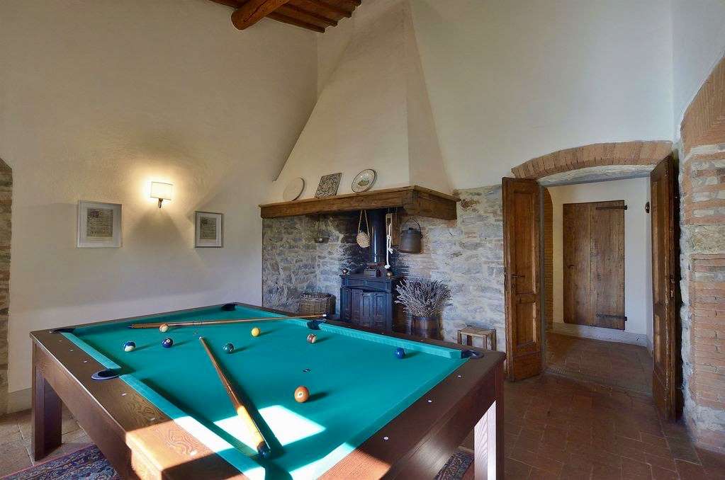 A view of the billiard table room showing the fireplace.